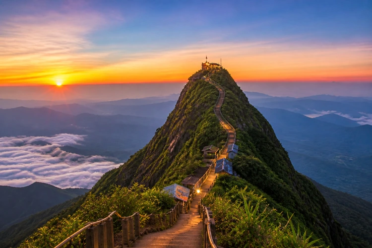 Adam’s Peak Sri Pada at sunrise with pilgrims climbing steps and mountain peak view Sri Lanka